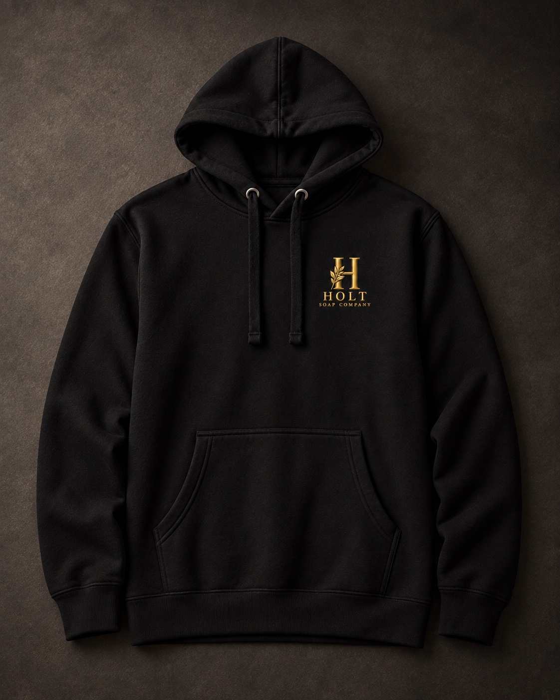 Black Holt pullover hoodie laid flat, with a gold chest logo