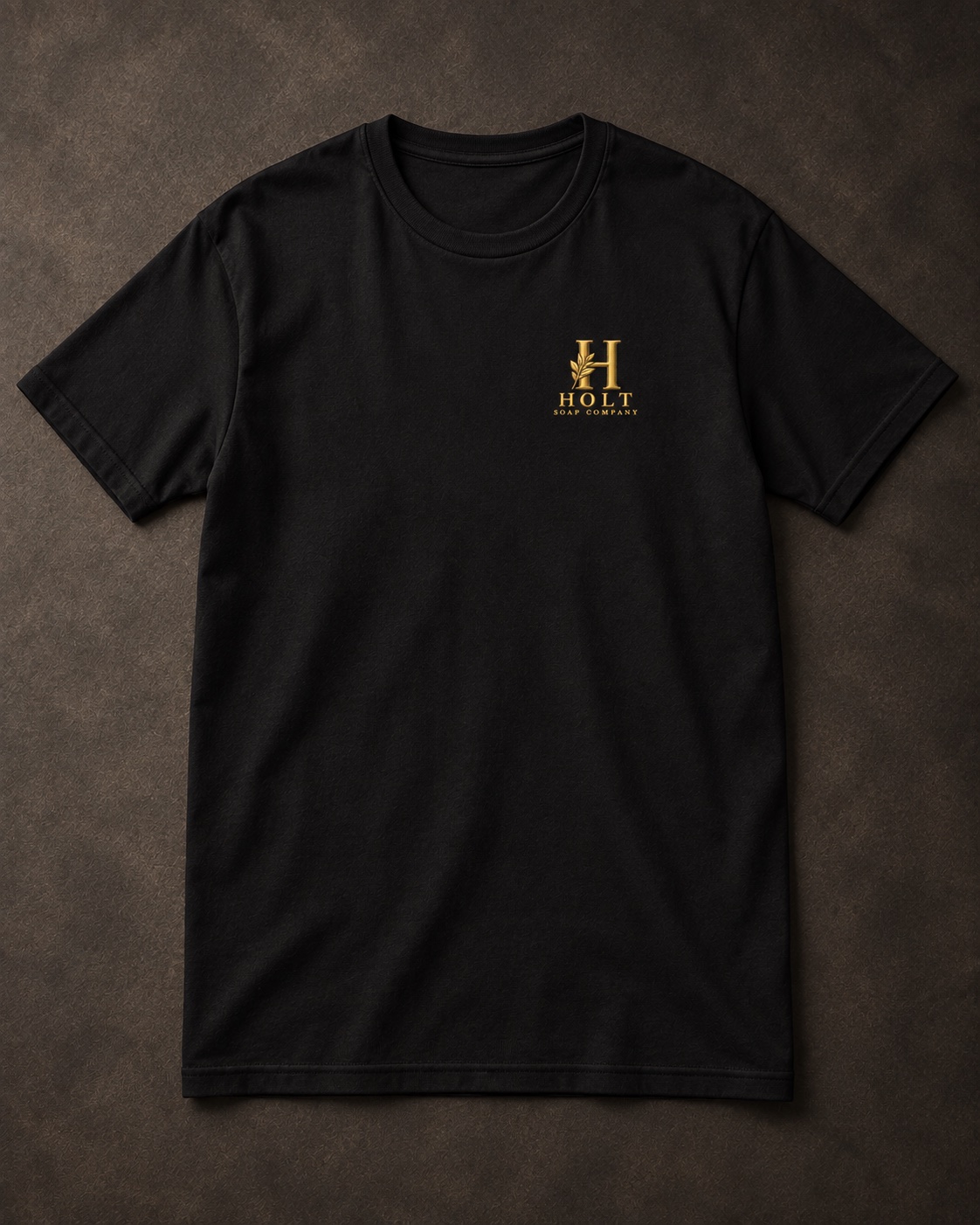 Front view of the black Holt Soap Tee with a small gold chest mark