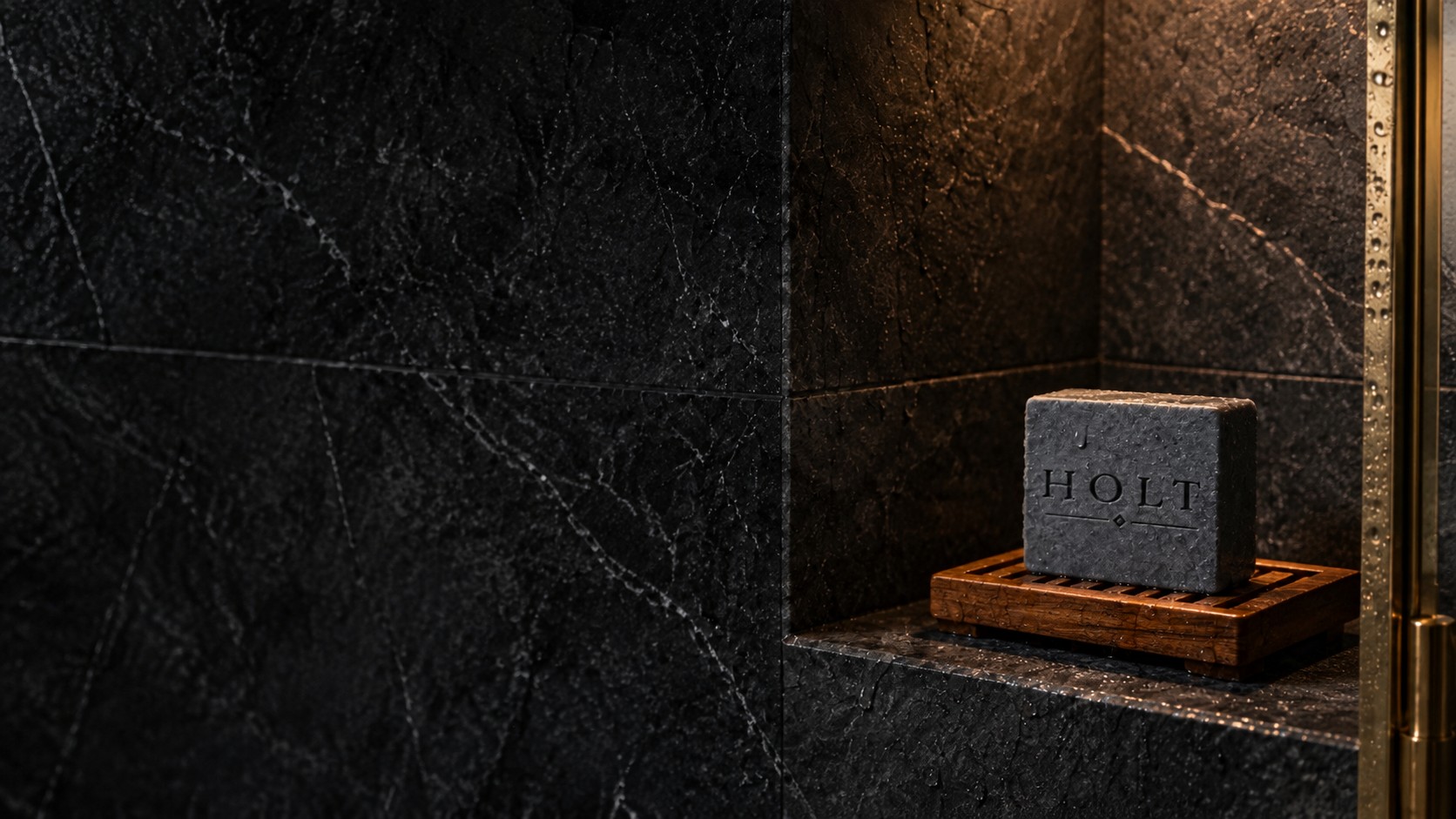 Holt soap in a softly lit stone shower niche